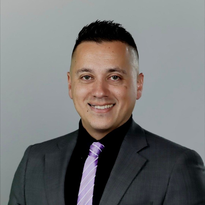 a Cox employee in a suit and tie