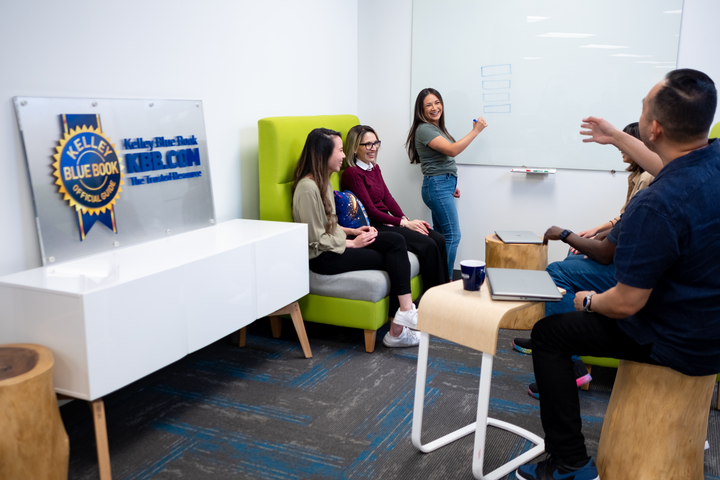 Kelly Blue Book Employees collaborating on whiteboard