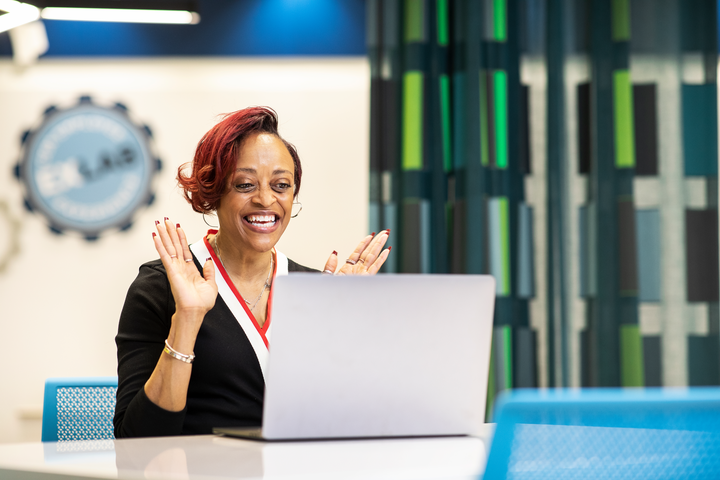 COX IBT employee looking at computer with excitement