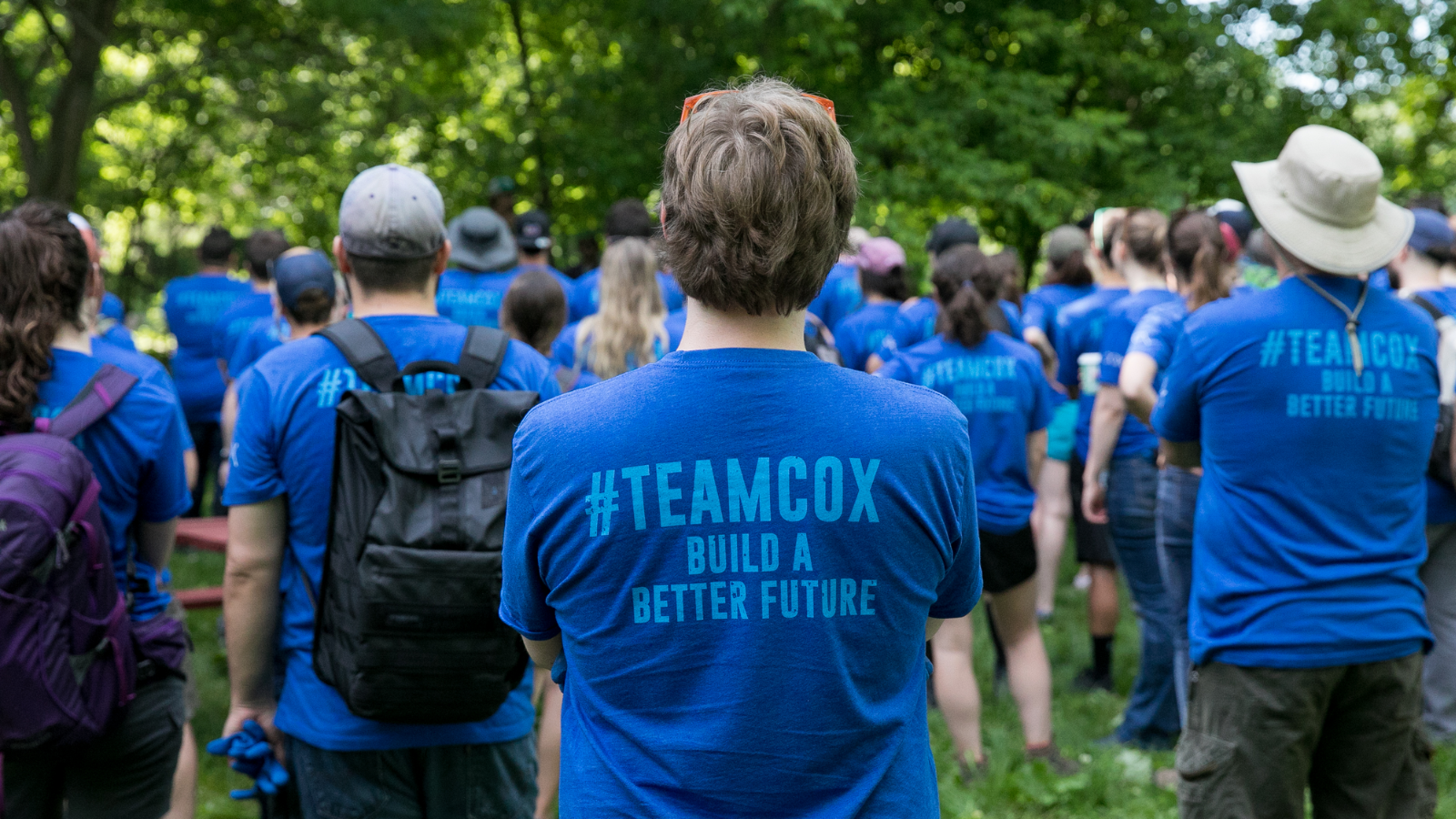 a group of people in blue shirts