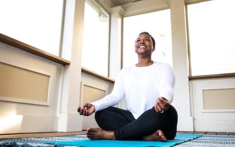 a person sitting on a yoga mat