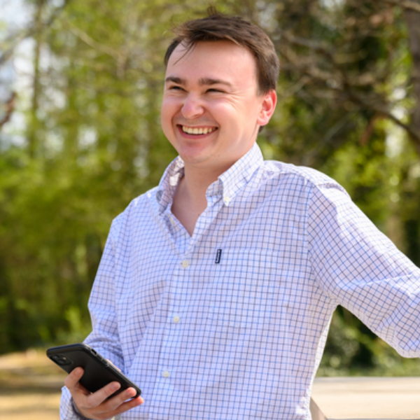 a Cox employee smiling outdoors