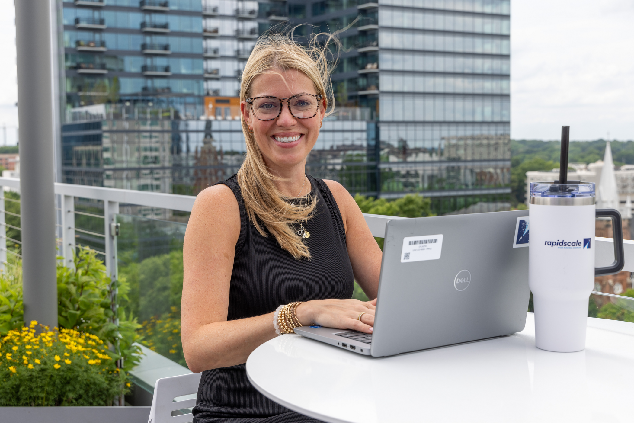 a person sitting at a table with a laptop