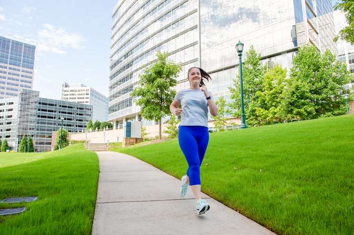 Cox employee running outdoors on campus