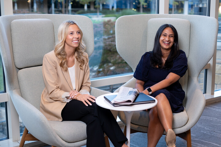two Cox employees sitting in chairs
