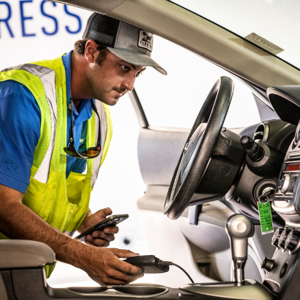 a Cox auto tech fixing vehicle