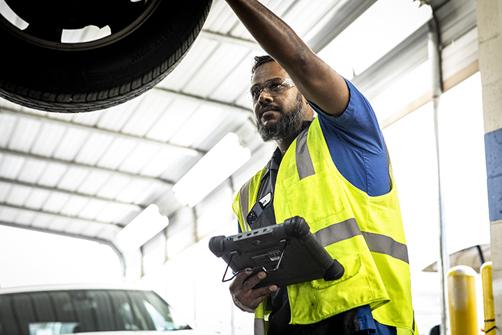 a Cox auto tech fixing vehicle