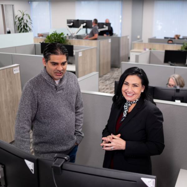 Cox employees looking at a computer