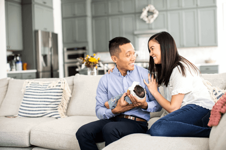 Cox employee smiling on couch with family