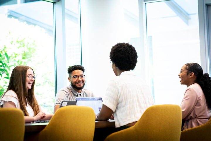 Cox employees collaborating at a table
