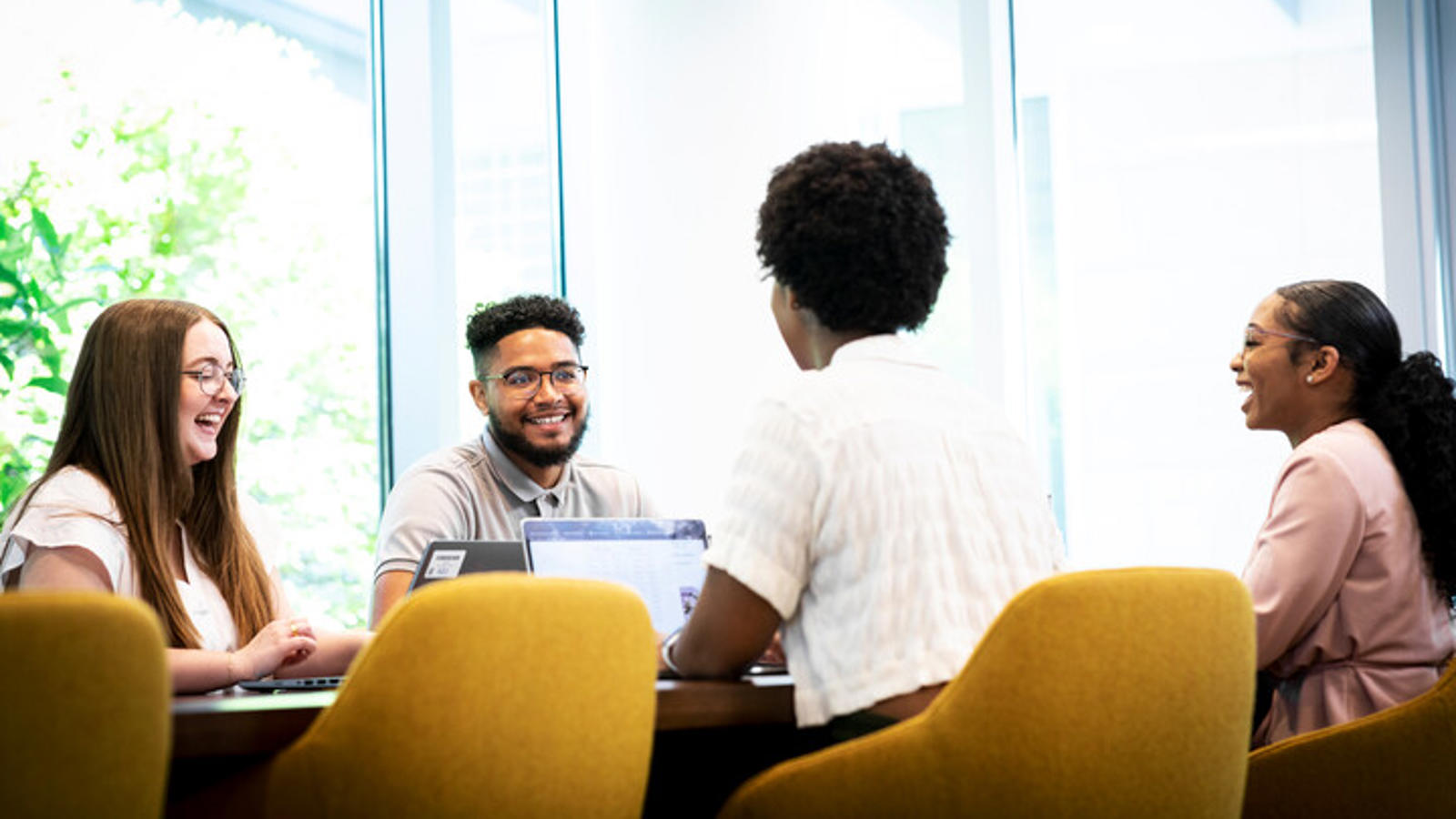 Cox employees collaborating at a table