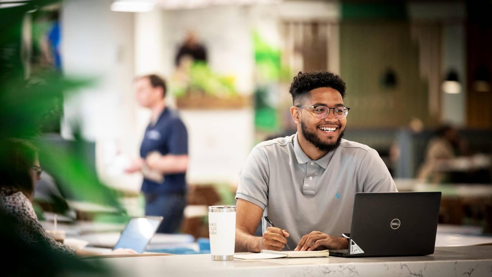 a Cox employee working on computer