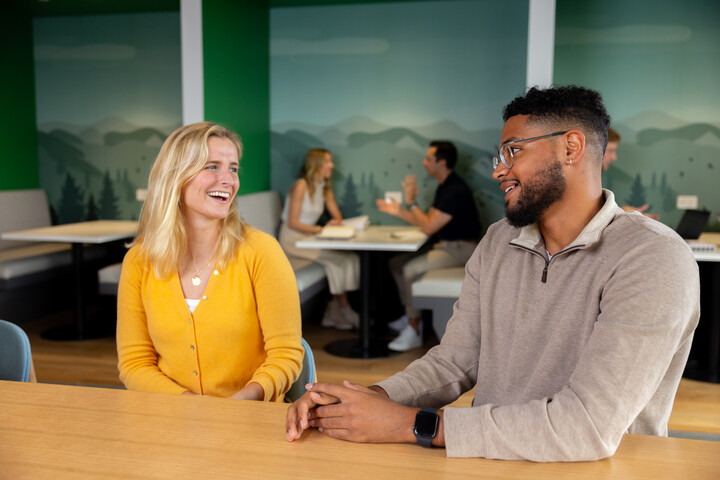 two Cox employees sitting at a table