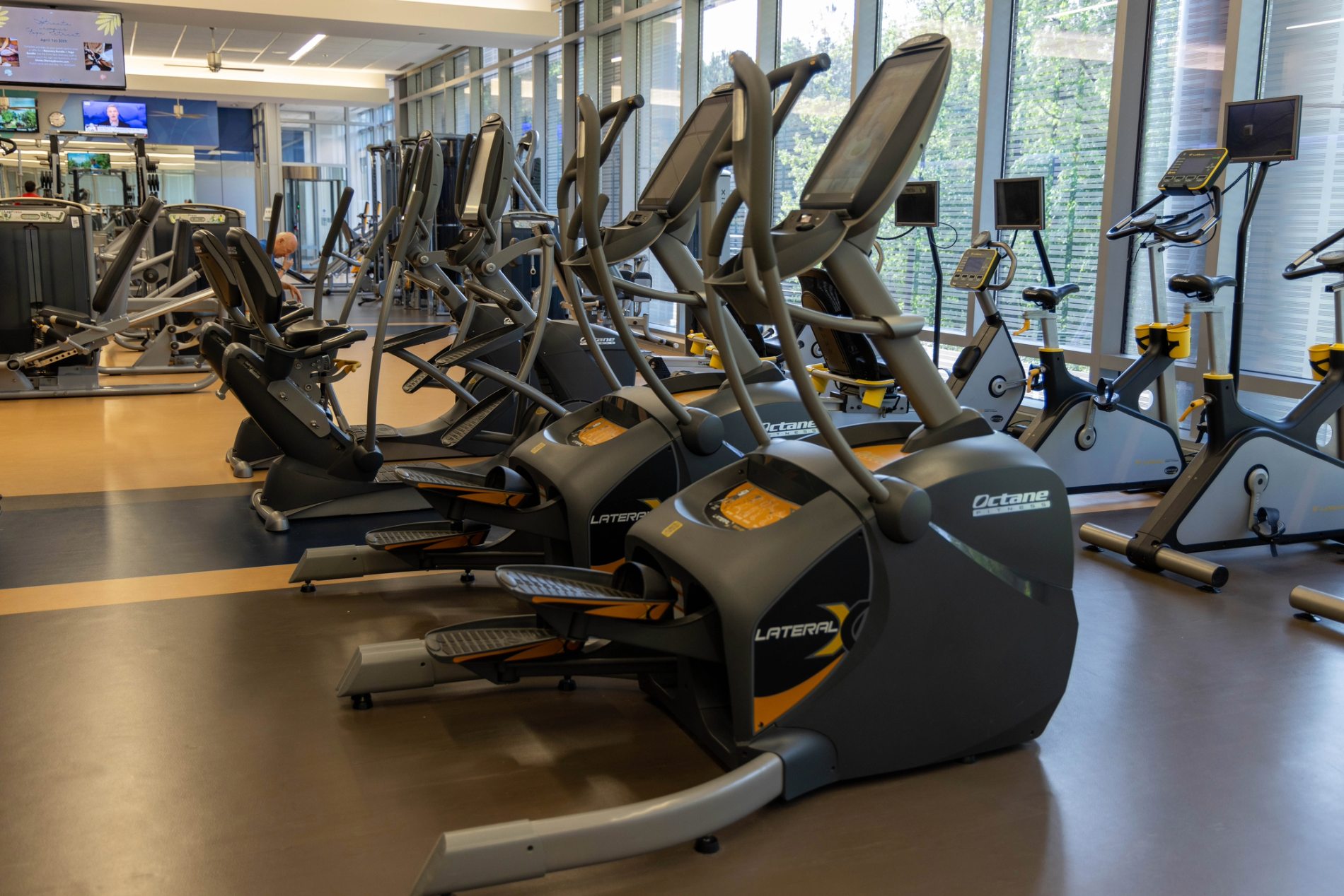 a group of exercise machines in a gym