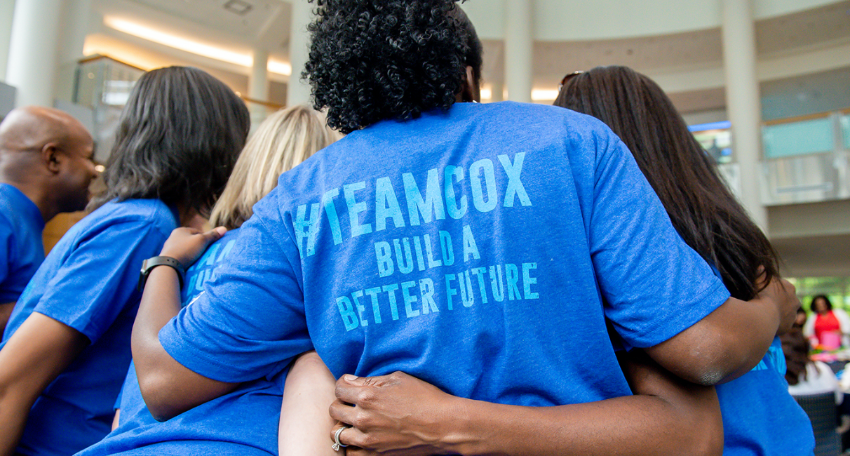 Cox employees in volunteer shirts