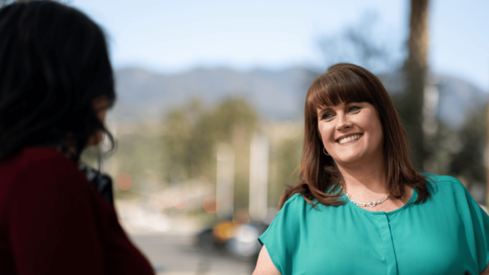 a Cox employee smiling at another person