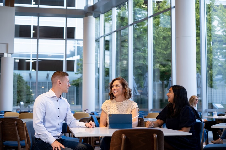 a group of Cox employees sitting at a table