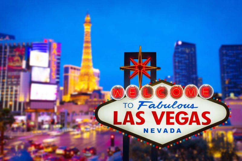 a sign with a city in the background