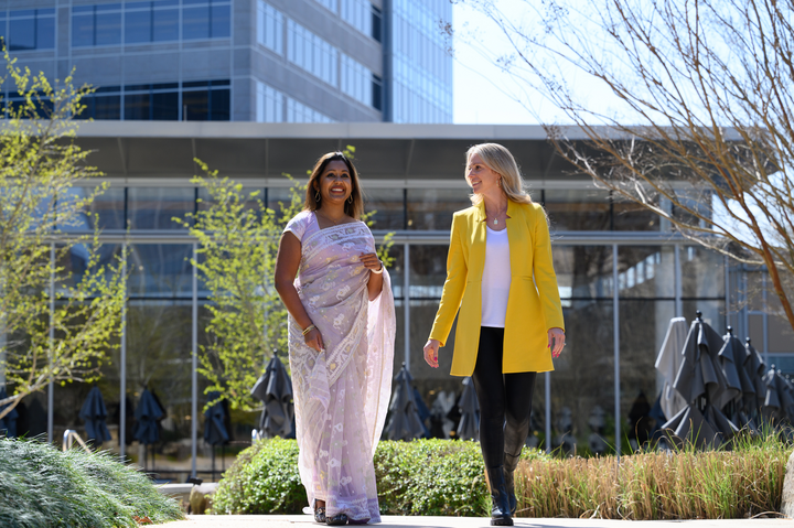 Cox employees walking outside Cox campus