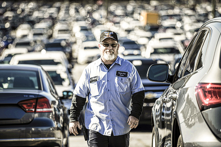 Cox auto tech walking in a parking lot