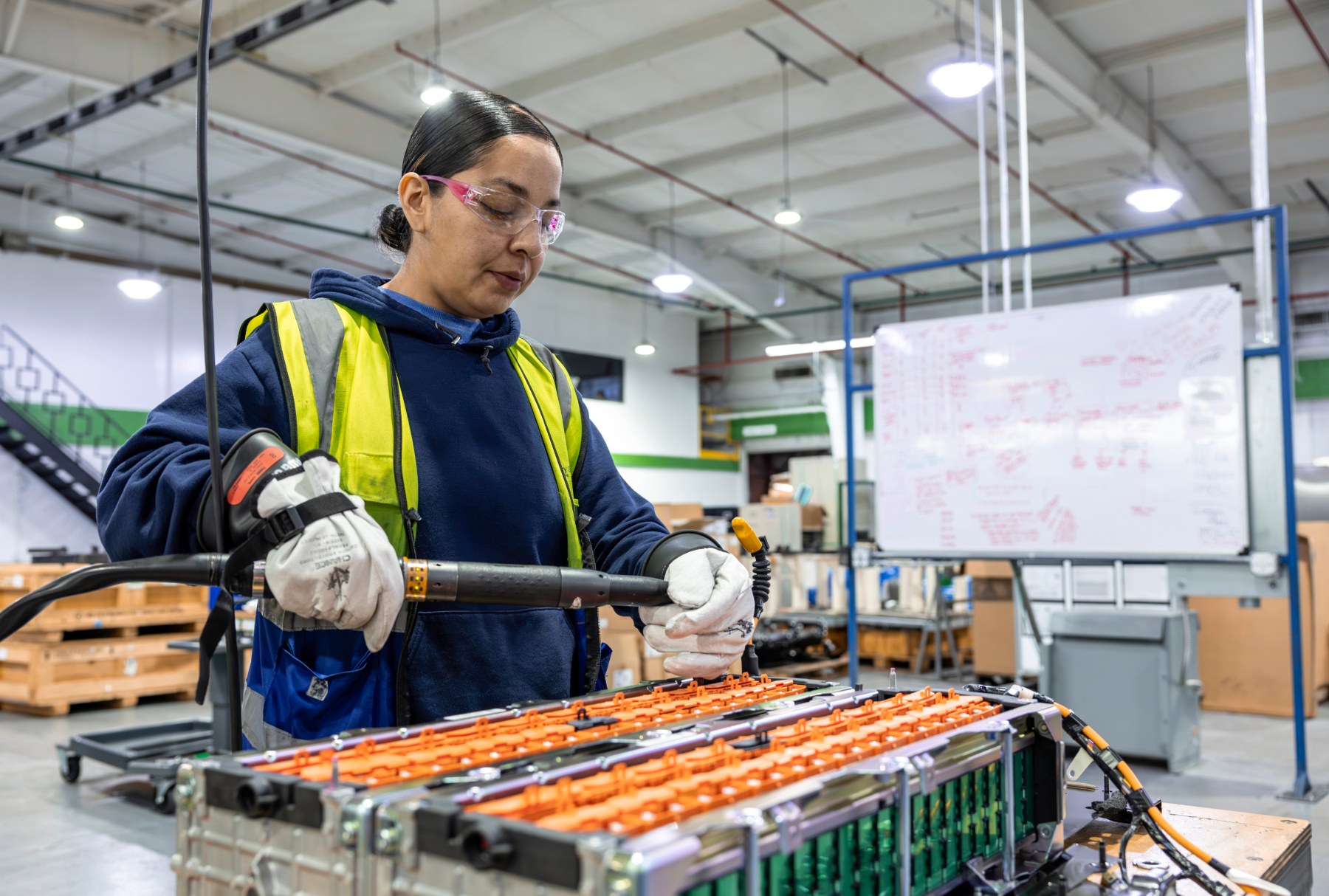 Cox Employee working on EV battery