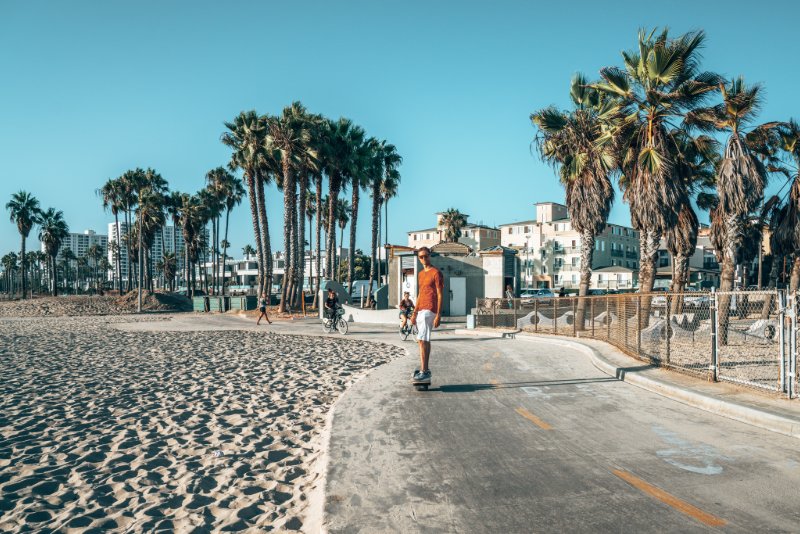 a person riding a skateboard on a beach
