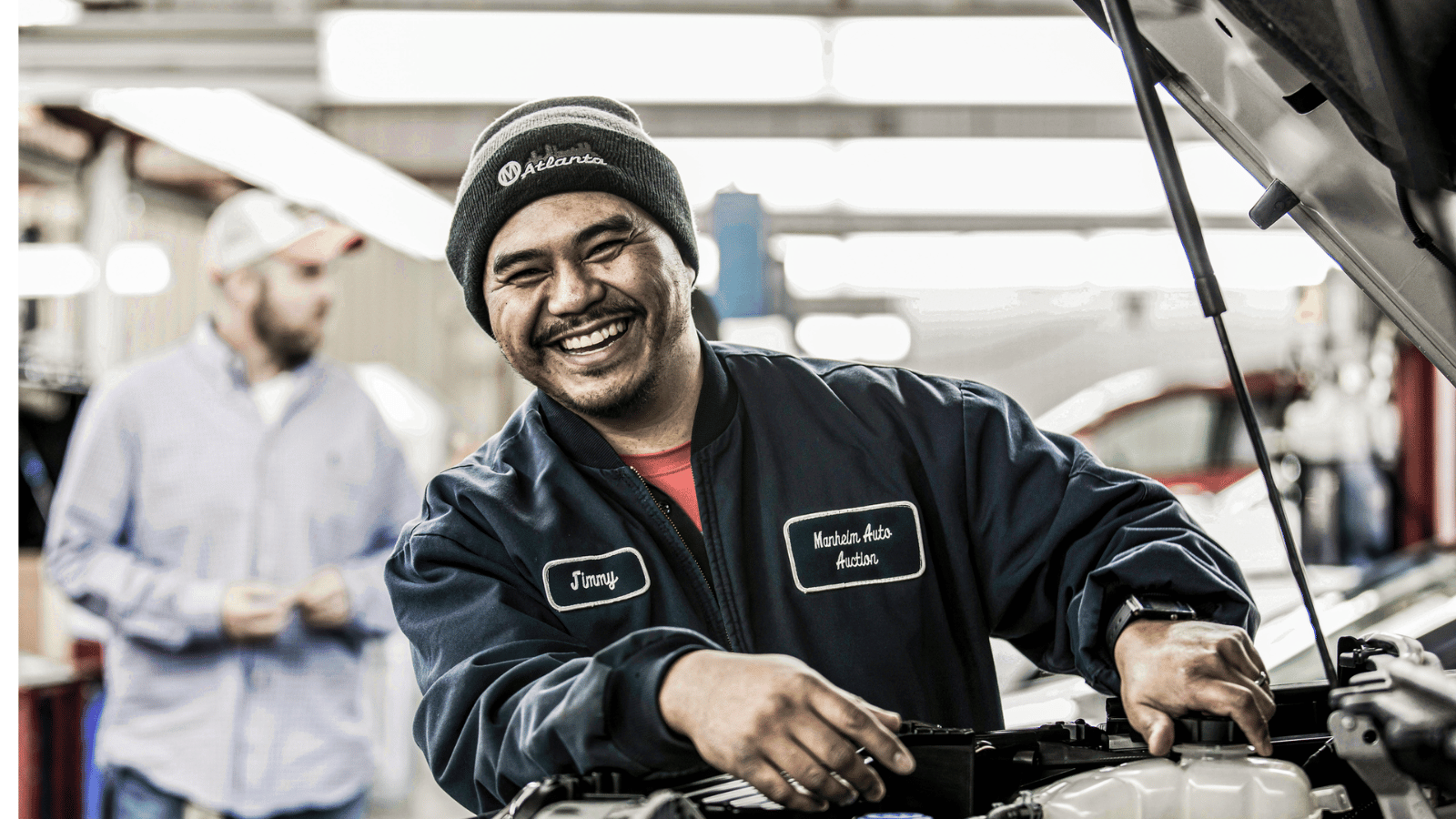 a Cox Automotive technician smiling at the camera