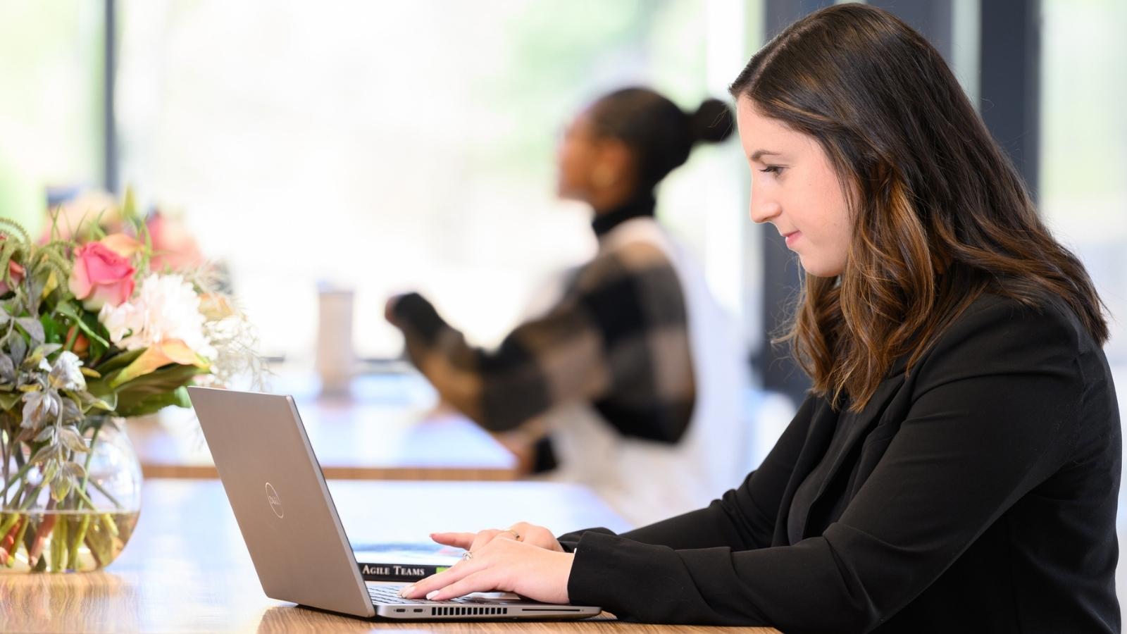 Cox Automotive employee working on laptop
