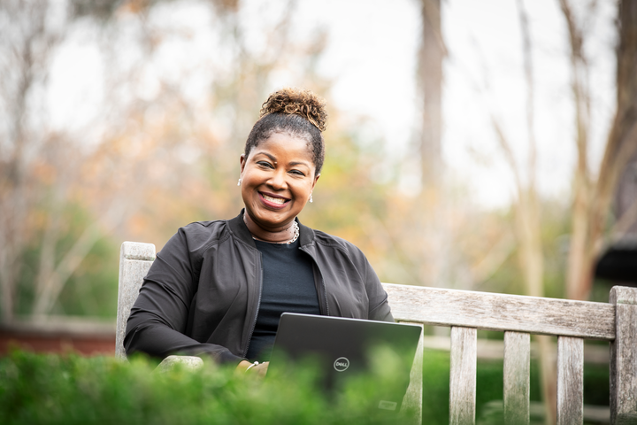 Cox employee working on laptop outdoors (3)