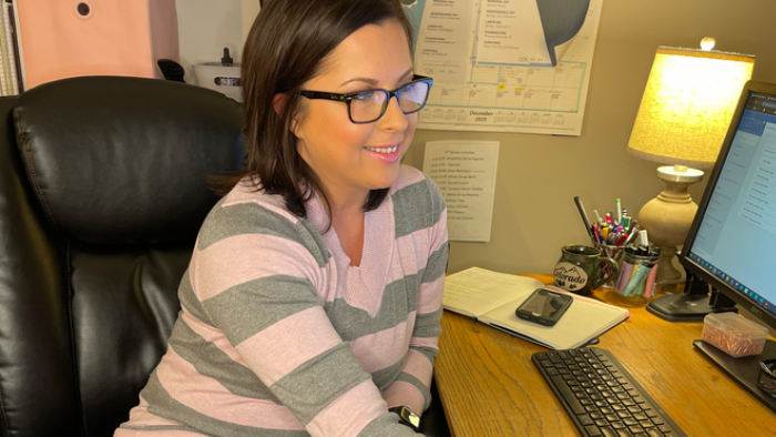 a Cox employee working on a computer from home