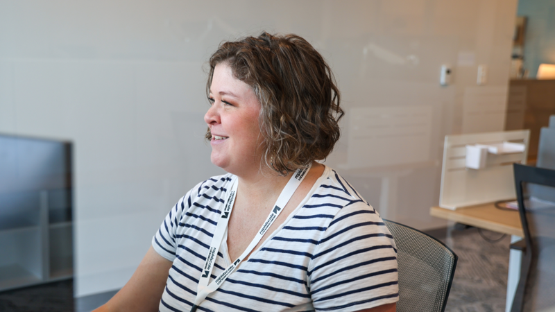 a person smiling in a striped shirt