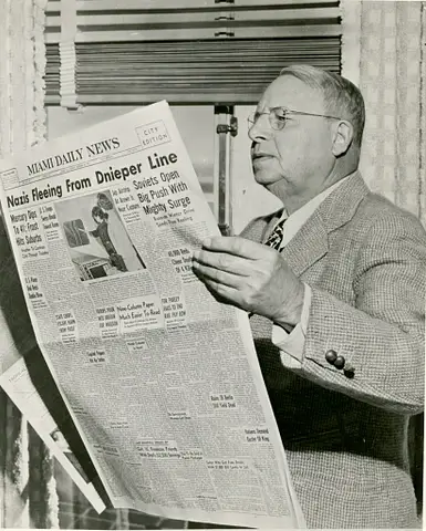 Governor cox with a  Newspaper
