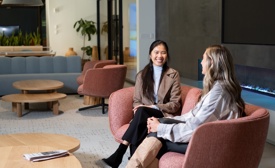 two women sitting in chairs