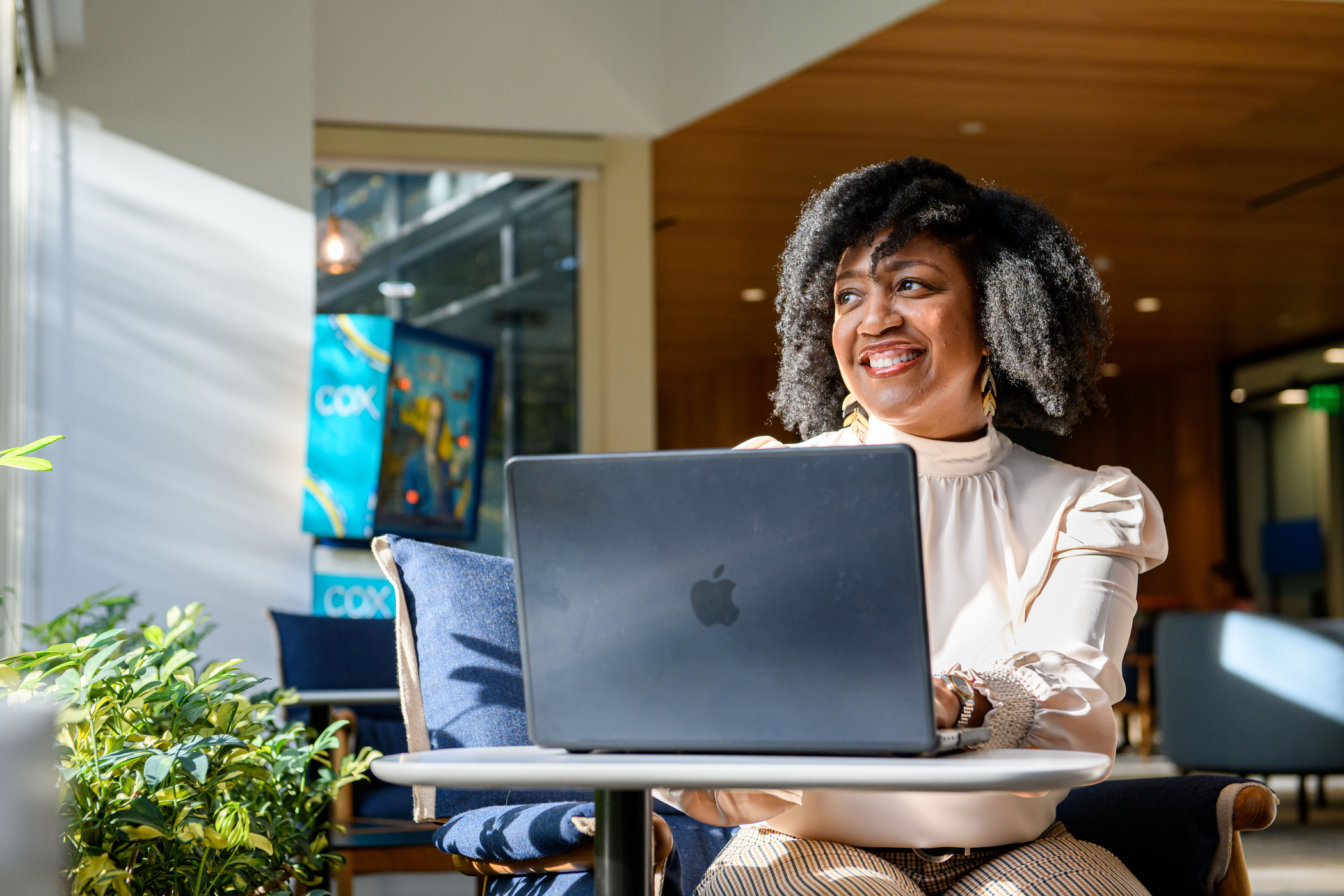 a person sitting at a table with a laptop