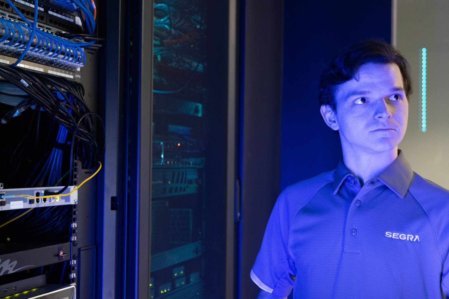 Segra employee standing in front of a server