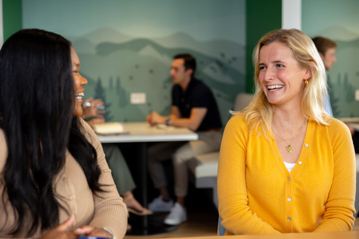 two Cox employees sitting at a table