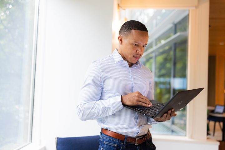 Cox employee on laptop